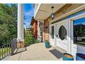 Charming front porch featuring a unique oval-windowed door and decorative details at 1438 N Franklin St # 100, Denver, CO 80218