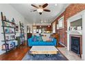 Inviting living room featuring a red brick wall, fireplace, and an open floor plan to the kitchen at 1438 N Franklin St # 100, Denver, CO 80218