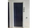 Entry door with modern hardware, a video doorbell, and a unit number on a well-maintained exterior at 16841 Askins Loop # 208, Parker, CO 80134