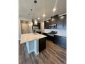 Well-equipped kitchen featuring a central island, stainless steel appliances, and ample counter space at 16841 Askins Loop # 208, Parker, CO 80134