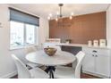Bright dining area with modern light fixture and stylish accent wall at 3355 S Flower St # 95, Lakewood, CO 80227