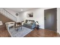Comfortable living room featuring stylish decor, modern art, and easy access to the staircase at 3355 S Flower St # 95, Lakewood, CO 80227