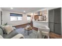 Cozy living room open to kitchen with modern decor, comfortable seating, and hardwood floors at 3355 S Flower St # 95, Lakewood, CO 80227