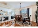 Elegant dining room featuring gleaming hardwood floors and stylish furniture at 20336 E 48Th Dr, Denver, CO 80249