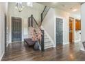 Inviting entryway featuring hardwood floors, a staircase with iron railings, and a decorative vase at 14223 Piney River Rd, Broomfield, CO 80023