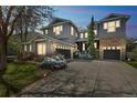 Charming two-story home with a stone facade and a spacious driveway, complemented by green landscaping at 14223 Piney River Rd, Broomfield, CO 80023