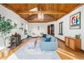 Bright and open living room featuring hardwood floors, fireplace and wood ceiling at 2646 Colorado Blvd, Denver, CO 80207