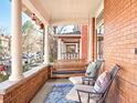 Inviting front porch features comfortable seating, a swing, and views of the neighborhood at 1557 Fillmore St, Denver, CO 80206