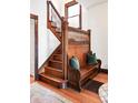 Charming foyer boasts original wood staircase and built-in bench with storage at 1557 Fillmore St, Denver, CO 80206