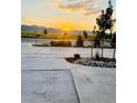Scenic street view at sunset, showcasing well-maintained landscaping and the tranquil beauty of the surrounding mountains at 9032 Middle Fork St, Littleton, CO 80125