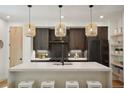 Modern kitchen with dark cabinetry, white countertops, and stylish pendant lighting at 1838 Pearl # C, Boulder, CO 80302
