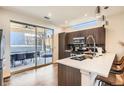 Modern kitchen with stainless steel appliances, sleek cabinetry, and seamless flow to outdoor patio at 3361 Mariposa St, Denver, CO 80211