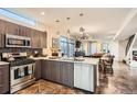 Modern kitchen with stainless steel appliances and an open floorplan to the living room and dining area at 3361 Mariposa St, Denver, CO 80211