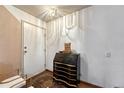 Inviting entryway featuring tile floors, a charming secretary desk, and a stylish light fixture at 3502 S Kittredge St # C, Aurora, CO 80013