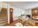 Cozy living room featuring a fireplace, staircase, and comfortable seating at 3502 S Kittredge St # C, Aurora, CO 80013