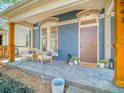 Inviting front porch with seating, charming decor, and stylish architectural details at 541 Fox St, Denver, CO 80204