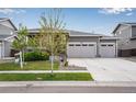 Charming single-story home with a well-manicured lawn and a two-car garage at 3022 Merlin Dr, Brighton, CO 80601