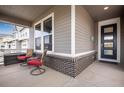 Inviting front porch with comfortable seating perfect for relaxing and enjoying the outdoors at 3022 Merlin Dr, Brighton, CO 80601