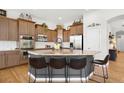 Well-equipped kitchen featuring granite countertops, a curved island with seating, and stainless steel appliances at 15502 E Flower Mound Pl, Parker, CO 80134