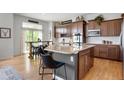 Modern kitchen with a large island, granite countertops, stainless steel appliances, and a breakfast bar at 15502 E Flower Mound Pl, Parker, CO 80134