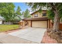 Charming two-story home with a spacious driveway and brick-lined pathway to the front entrance at 4617 S Norfolk Way, Aurora, CO 80015