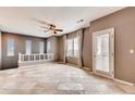 Open-concept living room features large windows, neutral paint, and elegant tile flooring for a bright and airy atmosphere at 12914 Grant Cir # C, Thornton, CO 80241