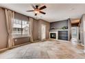 Comfortable living room featuring a fireplace and built-in shelves, complete with stylish tile floors and natural light at 12914 Grant Cir # C, Thornton, CO 80241