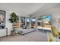 Sunroom with neutral chaise lounge and sliding doors to a private outdoor space at 8005 Emerald Ln, Broomfield, CO 80020