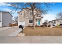 Two-story home with neutral siding, one car garage, a well manicured lawn, and mailbox at 1215 Finch Ave, Brighton, CO 80601