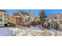 Townhome exterior with walkway, landscaping, and snow on the ground at 2134 S Scranton Way, Aurora, CO 80014