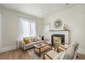 Cozy living room with ample sunlight, modern decor, and fireplace at 715 W 7Th Ave, Denver, CO 80204