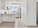 Modern kitchen with white cabinets, granite countertops, and stainless steel appliances at 8678 Decatur St # 288, Westminster, CO 80031