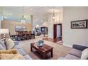 Spacious open-concept living and dining area with elegant lighting and large windows at 3462 W 109Th Cir, Westminster, CO 80031