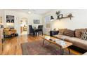 Open-concept living room featuring hardwood floors and a dining area with abundant natural light at 3130 S Washington St, Englewood, CO 80113