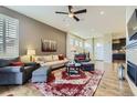 Spacious living room with hardwood floors, a stylish rug, and ample seating at 3477 New Haven Cir, Castle Rock, CO 80109