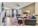 Spacious living room features hardwood floors, fireplace, comfortable seating, and an open floor plan at 3477 New Haven Cir, Castle Rock, CO 80109