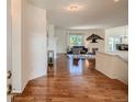 Bright foyer with hardwood floors leading into a spacious living area with lots of natural light at 7746 S Valdai Ct, Aurora, CO 80016