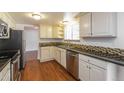 Bright kitchen with white cabinetry, stainless steel appliances, and decorative backsplash at 17209 E Evans Dr, Aurora, CO 80013