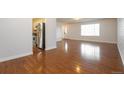 Open-concept living room with gleaming hardwood floors and plenty of natural light at 17209 E Evans Dr, Aurora, CO 80013