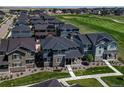 Nice aerial view of homes in a residential neighborhood near a green golf course at 16544 E 118Th Dr, Commerce City, CO 80022