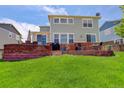 Spacious backyard with a brick retaining wall and mature lawn at 24351 E Alamo Dr, Aurora, CO 80016