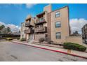 Inviting condo with brick accents and multiple balconies on a sunny day at 15350 E Arizona Ave # 106, Aurora, CO 80017