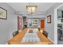 Dining room featuring hardwood floors, decorative lighting, and large dining table at 1648 S Locust St, Denver, CO 80224
