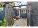 Charming front porch with seating, plants, and a cozy entrance to the home at 1648 S Locust St, Denver, CO 80224