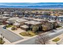 Aerial view of a neighborhood showcasing lovely homes with well-maintained lawns and mountain views at 9109 Ironwood Way, Highlands Ranch, CO 80129