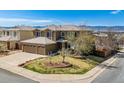 Beautiful two-story home with a three-car garage and manicured lawn, set against a backdrop of mountains at 9109 Ironwood Way, Highlands Ranch, CO 80129