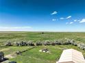 This aerial shot features a gazebo and large field, with a house and shop on the property at 68251 E 96Th Ave, Byers, CO 80103