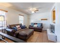 Comfortable living room with tile flooring, sofas with throw pillows, and a ceiling fan at 19630 E Purdue Pl, Aurora, CO 80013