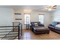Cozy living room with tile flooring, comfortable leather sofas, and plenty of natural light at 19630 E Purdue Pl, Aurora, CO 80013