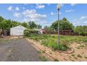 Large backyard featuring a detached garage, shed, and pergola, with potential for landscaping at 5935 Blanca Ct, Golden, CO 80403